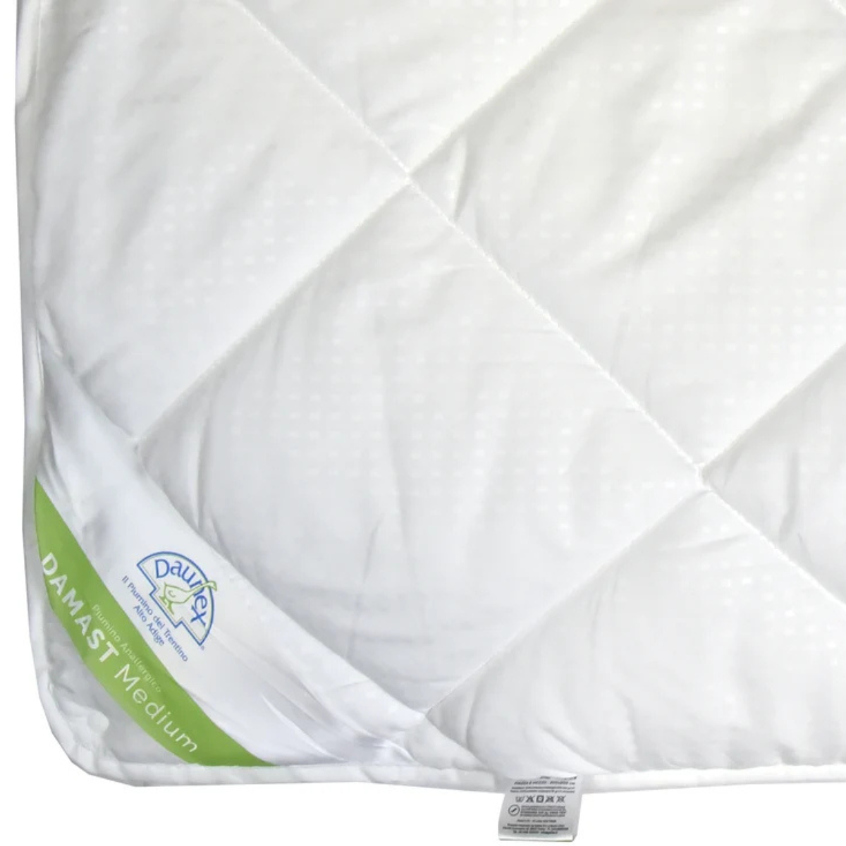 Dettaglio piumino Daunex Damast Medium con trapuntatura a rombi e finitura manopesca
